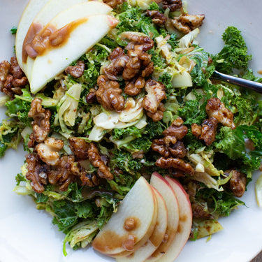 Shaved Brussels Salad with Date-Mustard Vinaigrette and Candied Date Syrup Walnuts